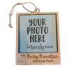 Elk Frame Ornament - Wooden Picture Frame with Elk, featuring "Your Photo Here" text and "Rocky Mountain National Park" branding, complete with a small illustration of an elk and a plane.