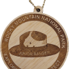 Junior Ranger Hat Ornament The Ornament - RMNP Junior Ranger Hat is a wooden keychain featuring the Rocky Mountain National Park logo with a ranger hat and the words "Junior Ranger. Explore. Learn. Protect" engraved.