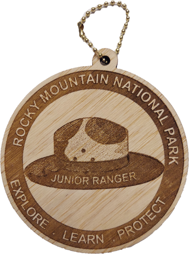 Junior Ranger Hat Ornament The Ornament - RMNP Junior Ranger Hat is a wooden keychain featuring the Rocky Mountain National Park logo with a ranger hat and the words "Junior Ranger. Explore. Learn. Protect" engraved.