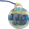Ornament - RMNP Bear with Cubs: A round souvenir from Rocky Mountain National Park, showcasing an illustration of a bear with two cubs in a forest setting, complete with a blue cord attached at the top.