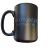 Black mug featuring blue text and a design associated with "Rocky Mountain National Park," known as the RMNP Bear Logo.