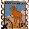 Magnet featuring a bighorn sheep stamp from Rocky Mountain National Park, valued at 15 cents.