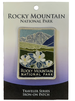 Rocky Mountain National Park "Traveler Series" patch on display card, highlighting white flowers and mountain imagery.
