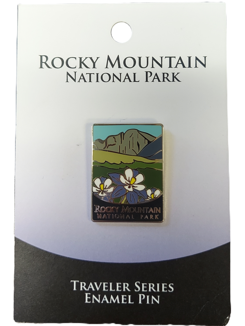 traveler pin Enamel pin showcasing mountains and flowers labeled "Rocky Mountain National Park," mounted on a card reading "Traveler Series Enamel Pin." Product: Pin - RMNP Traveler Series.