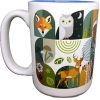 The RMNP Mod Collage Mug is a white ceramic mug decorated with illustrated woodland animals—fox, owl, and deer—plus green and earthy-toned foliage.