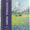 The Art of the National Parks - Undated Planner is a spiral-bound organizer with an illustrated cover featuring bears, wildflowers, pine trees, and a snow-capped mountain in the background.