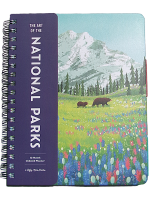 The Art of the National Parks - Undated Planner is a spiral-bound organizer with an illustrated cover featuring bears, wildflowers, pine trees, and a snow-capped mountain in the background.