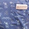 Close-up of the T-Shirt - Animal Icons Blue, showing fabric with outlines of bears, moose, and mountains plus a pocket labeled "Rocky Mountain National Park.