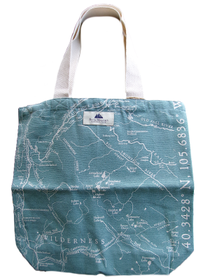 The Tote Bag - RMNP Map Turquoise features a printed wilderness map design and geographic coordinates along the right side, with sturdy white handles.