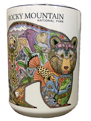 The Mug - RMNP Bear Collage is a ceramic mug displaying a vibrant bear illustration filled with detailed animals, plants, and landscapes, labeled "Rocky Mountain National Park.