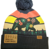 flower beanie back The Hat - Flower Bear Beanie is a knit beanie with a pom-pom, showcasing a vibrant landscape and bear design with flowers, plus a tag that reads "Heads Cozy. Planet Breezy.