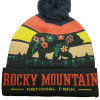 flower bear beanie The Flower Bear Beanie is a knit hat with a pom-pom, featuring a bear among flowers, a sunset pattern, and "ROCKY MOUNTAIN NATIONAL PARK" on the brim.