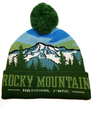 The Snowy Mountains Beanie is a green knit hat with a pom-pom, featuring a mountain and forest design plus "Rocky Mountain National Park" on the front cuff.