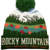 wildflower mtns beanie The Hat - Wildflower Mountains Beanie is a green, white, and multicolored beanie with a pom-pom, mountain and tree patterns, and "ROCKY MOUNTAIN NATIONAL PARK" text on the brim.