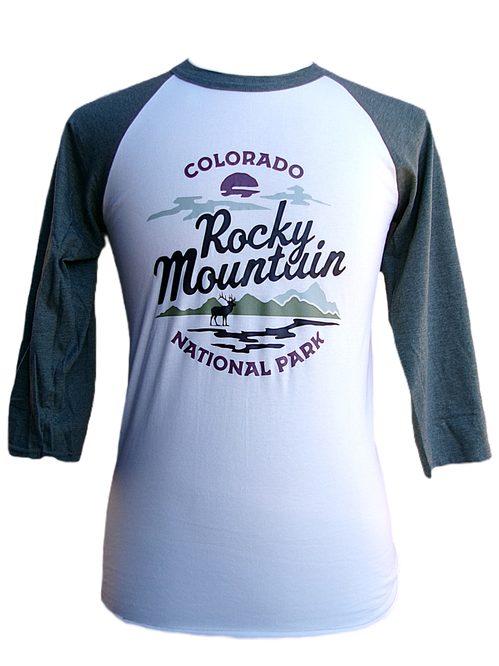 A white and green raglan long sleeve shirt featuring "Colorado Rocky Mountain National Park" and a graphic of mountains, trees, and a lake on the front. Product: Long Sleeve Shirt - RMNP Elk View.
