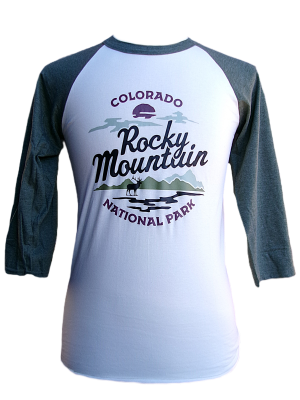 A white and green raglan long sleeve shirt featuring "Colorado Rocky Mountain National Park" and a graphic of mountains, trees, and a lake on the front. Product: Long Sleeve Shirt - RMNP Elk View.