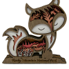 Magnet - RMNP Wooden Fox: A wooden fox figurine magnet with a carved landscape of trees and mountains inside, and “Rocky Mountain National Park” engraved on the base.