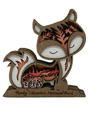 Magnet - RMNP Wooden Fox: A wooden fox figurine magnet with a carved landscape of trees and mountains inside, and “Rocky Mountain National Park” engraved on the base.