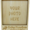 frame magnet Wooden magnet picture frame with "YOUR PHOTO HERE" engraved in the center and "Rocky Mountain National Park" with an elk at the bottom. Product name: Magnet - RMNP Wooden Picture Frame with Elk.