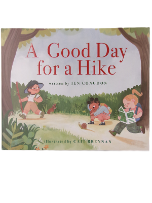 Three children hike in a forest: one leads with a stick, one examines the ground, and another reads "A Good Day for a Hike.