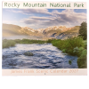 jf frony Cover of the 2027 James Frank Scenic RMNP Calendar featuring a river, lush greenery, and snow-capped mountains in Rocky Mountain National Park beneath a partly cloudy sky.