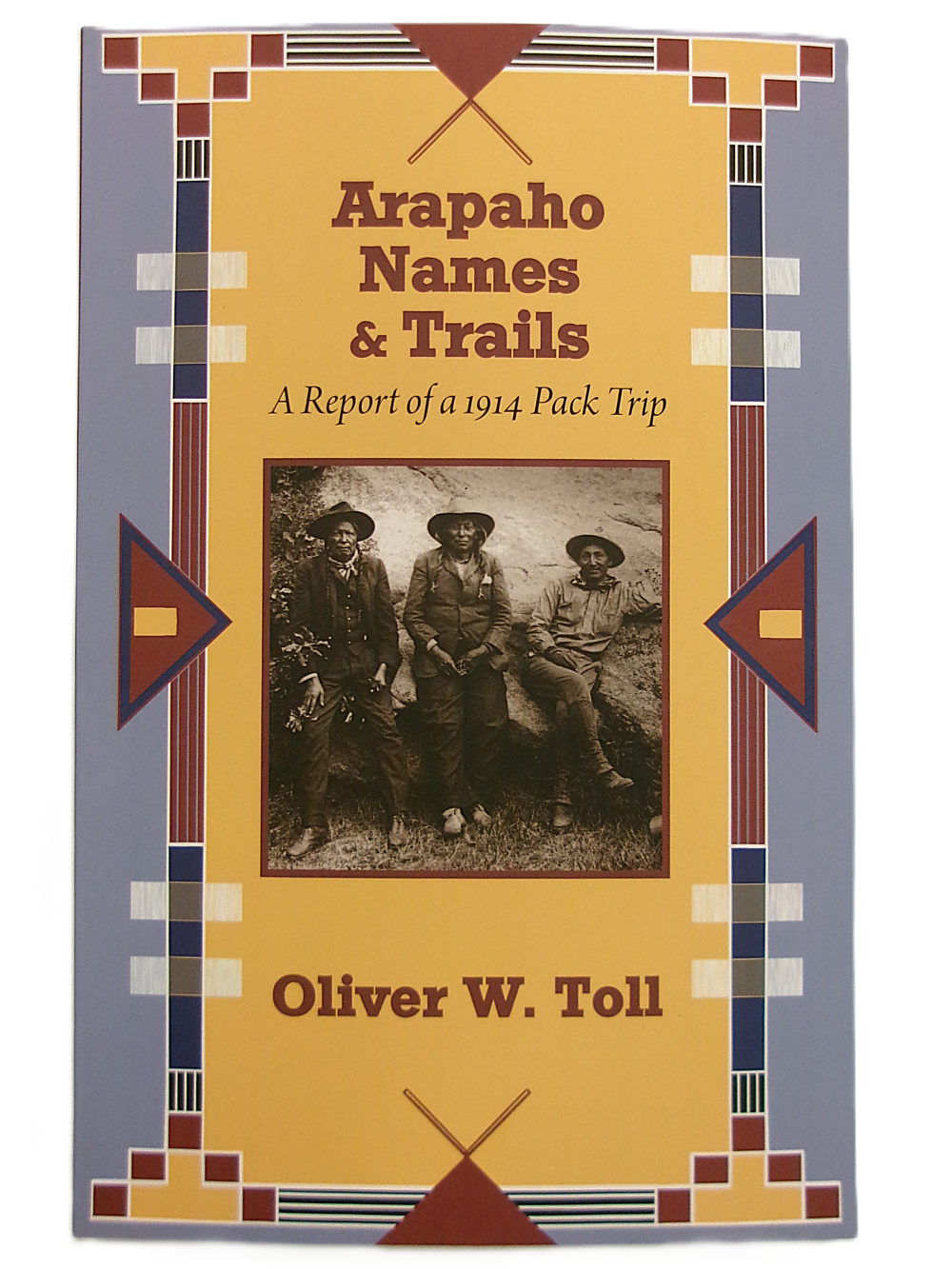 names and trails front Book cover of "Arapaho Names & Trails: A Report of a 1914 Pack Trip" features a sepia photo of three people in outdoor attire with geometric border designs.