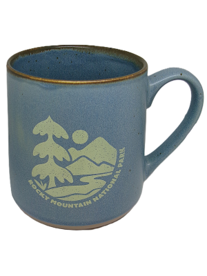The Mug - RMNP Speckled Wild River is a blue ceramic mug with a handle, decorated with trees, mountains, a sun graphic, and the text "Rocky Mountain National Park.
